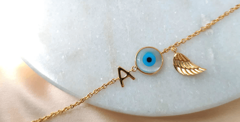 Evil Eye Initial Bracelet with a Wing